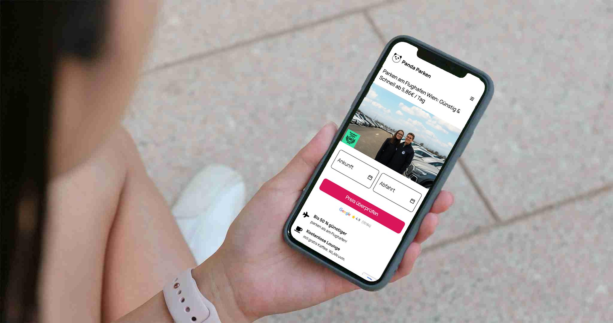 Holding phone with open panda parken website